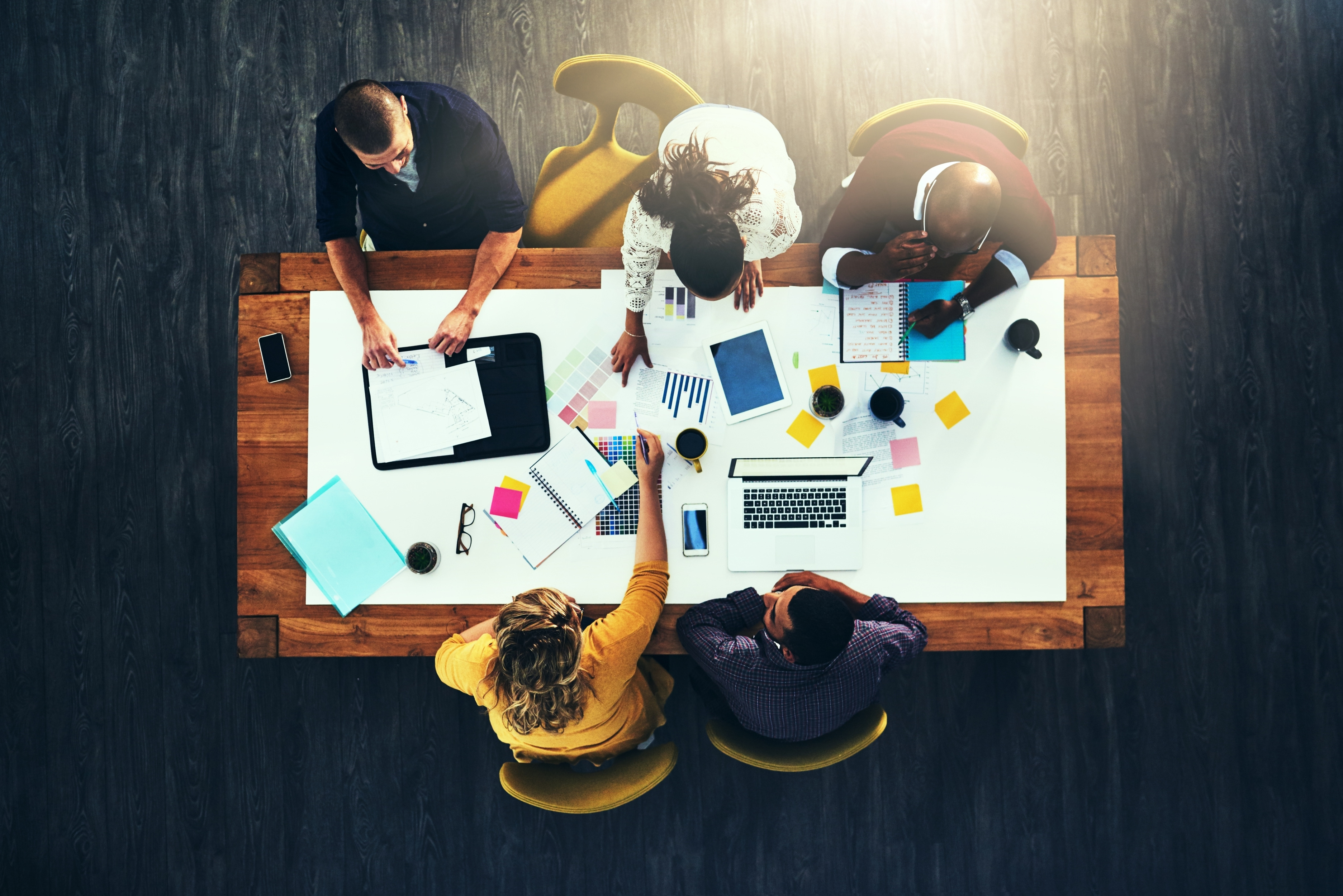 paperwork designers meeting color choice teamwork brainstorming startup creative group strategy with laptop people graphs with documents budget report feedback
